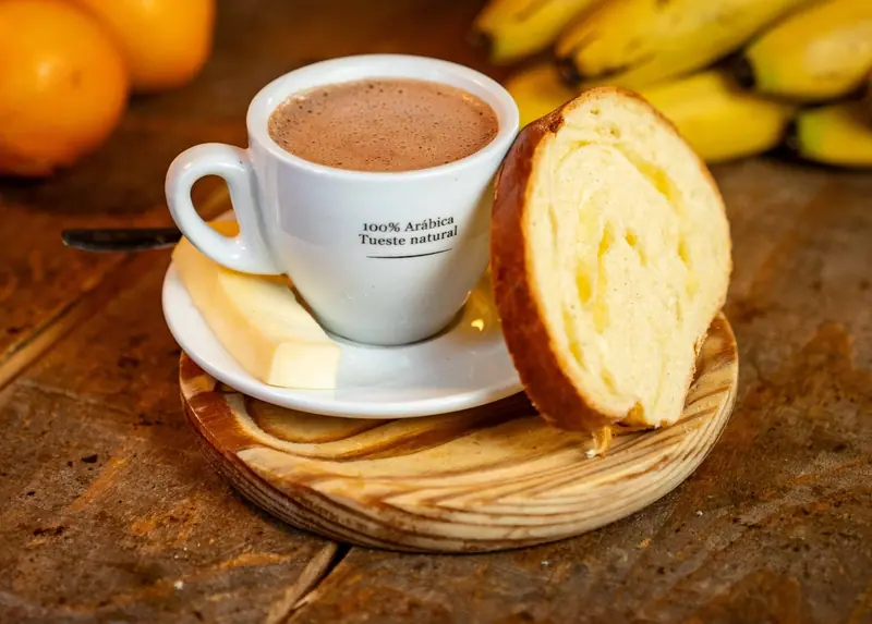 Taza de chocolate colombiano con pan y queso